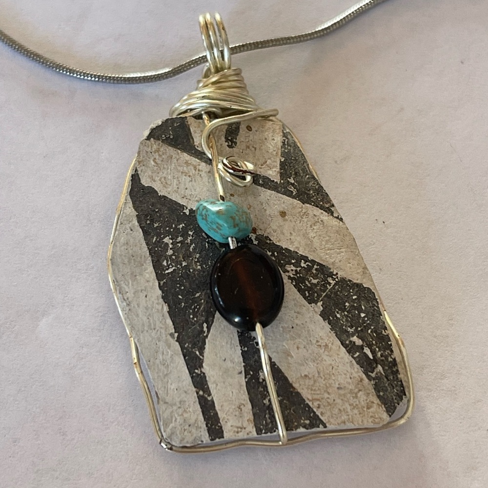 Stone wrapped in silver wire adorned with turquoise onyx necklace
